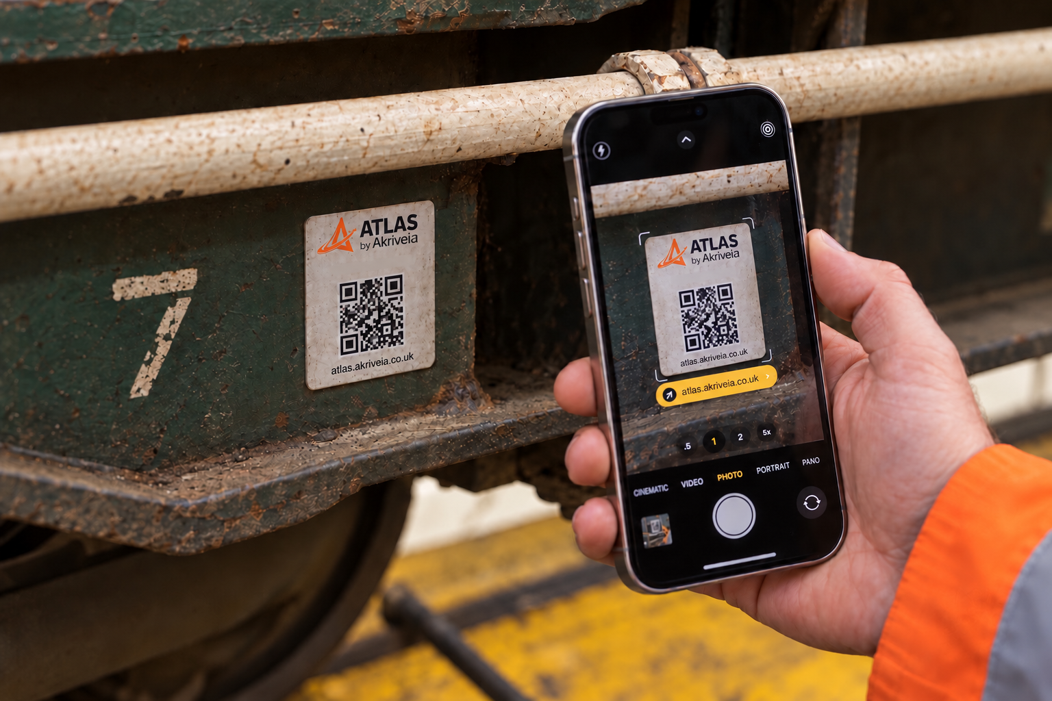 A workshop worker scanning an ATLAS QR label attached to a rail vehicle.